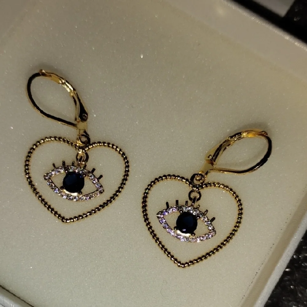 Gold Tone Heart Eye Earrings